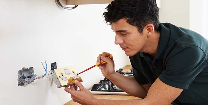 Home maintenance in Camberwell, man fixing electrical circuit.