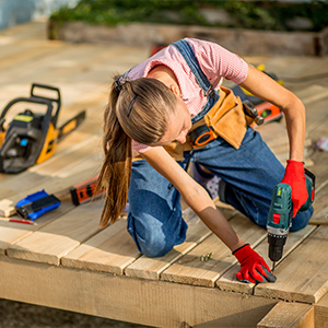 Home maintenance in Camberwell, handy women fixing a wooden deck.